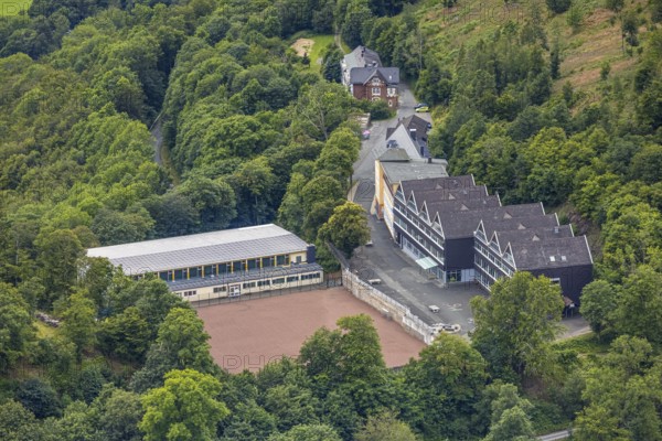 Aerial view, Wittgenstein Castle, grammar school and secondary school in the forest, Wittgenstein art, Bad Laasphe, Wittgensteiner Land, North Rhine-Westphalia, Germany, view, tree, educational institution, castle, monument, discovery, leisure, green, grammar school, hill, culture, art, landscape, Middle Ages, nature, panorama, secondary school, journey, location, school building, sight, summer, tourism, bird's eye view, forest, European, peaceful, historical architecture, rural, picturesque