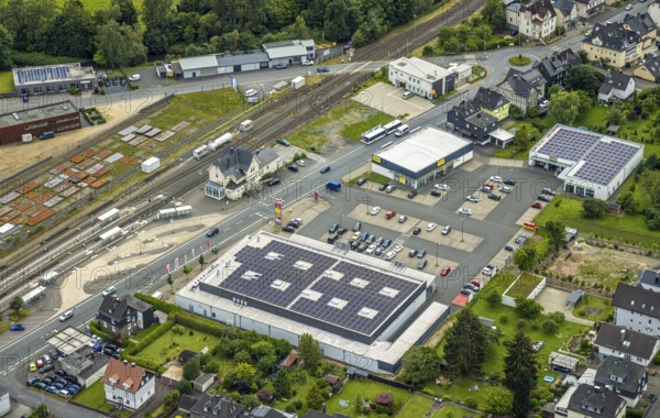Aerial view, Bahnhofstrasse shopping centre with Rewe supermarket and solar roof, Takko fashion and K+K shoes, Bad Laasphe railway station and station building, new police station, Bad Laasphe, Wittgensteiner Land, North Rhine-Westphalia, Germany, architecture, railway station, station building, shopping, shopping facilities, shopping centre, retail, building, business, trade, infrastructure, K+K Schuhe, fashion shop, sustainability, new build, police, police station, Rewe supermarket, shoe shop, shopping, solar system, solar roof, town, town planning, supermarket, Takko Fashion, transport, economy, regional, public facilities