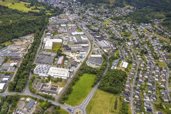 Aerial view, commercial area in the floodplain, roundabout Bahnhofstraße federal road, B62, residential area around Thüringer Weg and Hirtsgrunder Weg, Bad Laasphe, Wittgensteiner Land, North Rhine-Westphalia, Germany, architecture, drive, Bahnhofstraße, federal road, Europe, building, commercial area, Hirtsgrunder Weg, industry, infrastructure, roundabout, landscape, planning, region, settlement, town, urban development, road network, structure, Thüringer Weg, urban, traffic routes, residential area, residential buildings, civilisation, overview