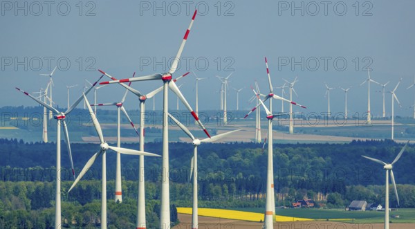 Aerial view, wind park and wind farm wind energy plant, wind turbines and rape fields near Radlinghausen, Messinghausen, Brilon, East Westphalia, Sauerland, North Rhine-Westphalia, Germany, wind park, wind farm, wind energy plant, wind turbines, rape fields, Radlinghausen, renewable energy, sustainable energy, environment, landscape, fields, nature, technology, energy production, rural, village, agricultural landscape, green, agriculture, aerial view, generative energy, alternative energy, clean energy, wind power, yellow fields