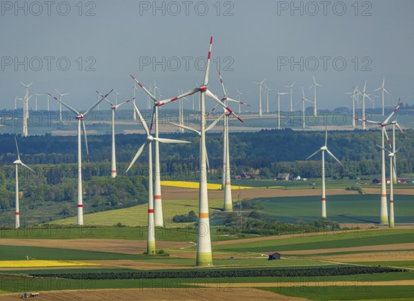 Aerial view, wind park and wind farm wind energy plant, wind turbines and rape fields near Radlinghausen, Messinghausen, Brilon, East Westphalia, Sauerland, North Rhine-Westphalia, Germany, wind park, wind farm, wind energy plant, wind turbines, rape fields, Radlinghausen, renewable energy, landscape, green, nature, agriculture, energy production, sustainability, environment, fields, rural, village, rural, infrastructure, engineering, technology, ecology, summer, sky, clean, power generation, perspective, aerial view