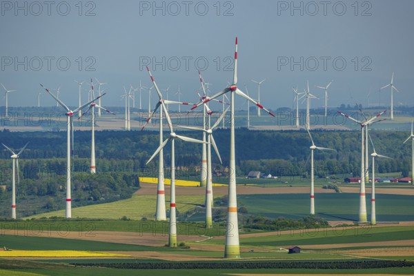 Aerial view, wind park and wind farm wind energy plant, wind turbines and rape fields near Radlinghausen, Messinghausen, Brilon, East Westphalia, Sauerland, North Rhine-Westphalia, Germany, wind park, wind farm, wind energy plant, wind turbines, rape fields, Radlinghausen, renewable energy, green energy, landscape, rural, fields, nature, climate, environmental protection, agriculture, energy production, sustainable energy, sky, horizon, infrastructure, technology, view, electricity, spring landscape, clean energy, environment, agricultural landscape, village, settlement, pollen, blossom, vastness, modernity, vegetation, corn, agroindustrial