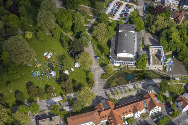 Aerial view, Congress Centre Bad Lippspringe, Arminius Park with castle ruins and river Lippequelle and Arminius Quelle Pavilion, Father's Day celebration in Arminius Park at the Congress Centre, visitors on the meadow, bouncy castle and drink stands, Bad Lippspringe, East Westphalia, North Rhine-Westphalia, Germany, Congress Centre, Arminius Park, castle ruins, river, Lippe spring, Arminius spring, pavilion, Father's Day festival, meadow, visitors, bouncy castle, drinks stands, event, celebration, leisure, open air, people, family, children, adults, culture, nature, park, architecture, history, tradition, town, landscape, green spaces, recreation, pleasure, summer, daylight, event, entertainment