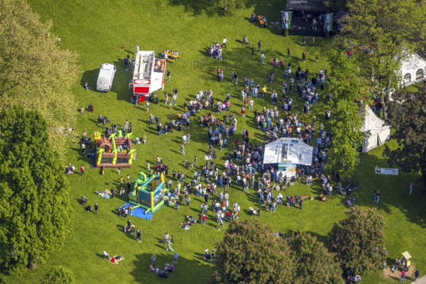 Aerial view, Father's Day festival in Arminius Park at the Congress Centre, visitors on the meadow, bouncy castle and drinks stands, Bad Lippspringe, East Westphalia, North Rhine-Westphalia, Germany, Father's Day festival, Arminius Park, Congress Centre, visitors, meadow, bouncy castle, beverage stands, leisure, celebration, outdoor, people, adults, children, family, game, fun, community, event, city, park, summer, day, sunny, recreation, pleasure, excursion, tradition, event, society, culture, nature, green space, entertainment