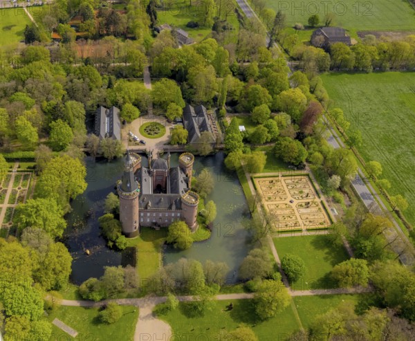 Aerial view, Museum Schloss Moyland, neo-Gothic moated castle and castle park surrounded by meadows and fields and forest, excursion destination on the Lower Rhine, Moyland, Bedburg-Hau, Lower Rhine, North Rhine-Westphalia, Germany, architecture, attraction, excursion destination, building, sightseeing, trees, recreation, fields, leisure, garden, history, green spaces, culture, landscape, aerial view, nature, panorama, park, Moyland Castle, castle park, beauty, sight, daylight, tourism, forest, moated castle, meadows, outdoors, peaceful, historic, neo-Gothic