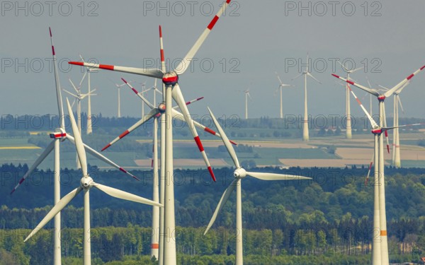 Aerial view, wind park and wind farm wind energy plant, wind turbines and rape fields near Radlinghausen, Messinghausen, Brilon, East Westphalia, Sauerland, North Rhine-Westphalia, Germany, wind park, wind farm, wind energy plant, wind turbines, rape fields, Radlinghausen, renewable energy, landscape, agriculture, environmentally friendly, green, sustainable energy, energy production, fields, infrastructure, technology, nature, photovoltaics, clouds, sky, aerial view, agricultural landscape, rural, spring, yellow, perspective from above, panorama, clean energy