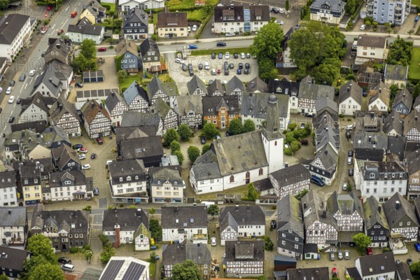 Aerial view, protestant town church and church square in the town centre with historic half-timbered houses, Bad Laasphe, Wittgensteiner Land, North Rhine-Westphalia, Germany, old town, architecture, tree, village, village centre, spring, building, history, green trees, autumn, sky, idyll, church, church square, church tower, culture, landscape, nature, town centre, panorama, religion, sight, settlement, summer, town, structure, daylight, tourism, tradition, European, protestant town church, historic half-timbered houses, rural, picturesque