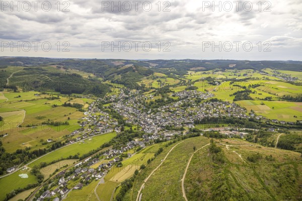 Aerial view, view of Feudingen residential area, hilly landscape with meadows and fields and distant view, sky with clouds, Feudingen, Bad Laasphe, Wittgensteiner Land, North Rhine-Westphalia, Germany, view, trees, village, Europe, fields, distant view, building, green, sky, houses, hilly landscape, idyllic, infrastructure, landscape, agriculture, nature, local view, panorama, region, settlement, summer, roads, daylight, meadows, residential area, clouds, peaceful, rural, quiet