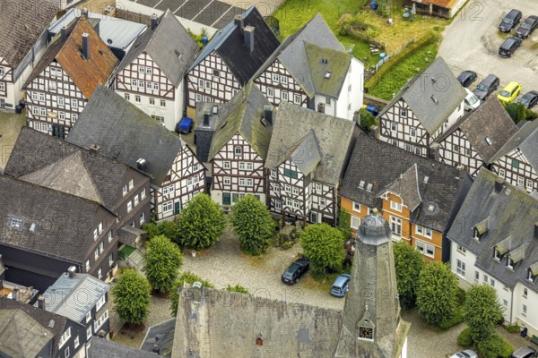 Aerial view, spire of the protestant town church and church square in the town centre with historic half-timbered houses, Bad Laasphe, Wittgensteiner Land, North Rhine-Westphalia, Germany, old town, architecture, treetops, village, building, history, green trees, church grounds, church square, church spire, culture, landscape, town centre, town centre, panorama, religion, shepherd's statue, sight, summer, town view, town centre, daylight, tourism, tradition, spire, European, protestant town church, historic half-timbered houses, rural, regional