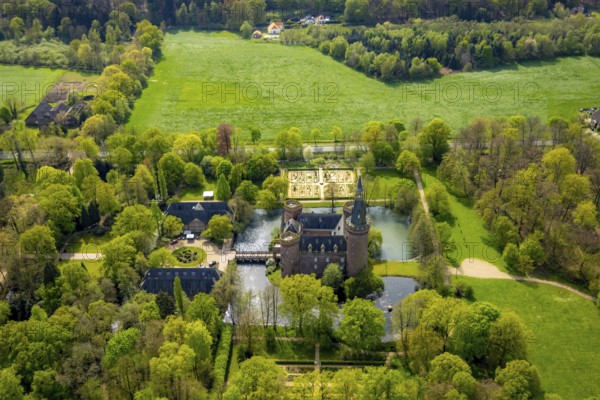 Aerial view, Museum Schloss Moyland, neo-Gothic moated castle and castle park surrounded by meadows and fields and forest, excursion destination on the Lower Rhine, Moyland, Bedburg-Hau, Lower Rhine, North Rhine-Westphalia, Germany, architecture, excursion destination, trees, recreation, fields, leisure, leisure activities, history, green spaces, idyllic, culture, landscape, nature, castle park, beauty, sight, daylight, tourism, forest, water, meadows, European, peaceful, historical, cultural, neo-Gothic moated castle