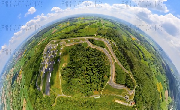 Aerial view, Bilster Berg race track, test track and presentation track, park-like terrain with paddock and off-road course, globe, fisheye image, fisheye image, 360 degree image, tiny world, little planet, Pömbsen, Bad Driburg, East Westphalia, North Rhine-Westphalia, Germany, test track, presentation track, park-like, terrain, paddock, off-road course, fisheye image, track, circuit, motorsport, landscape, trees, nature, automobile, racing, bird's eye view, panorama, circle, round, sky, outdoor, technology, innovation, architecture, infrastructure