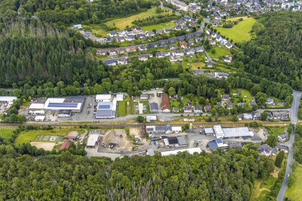 Aerial view, Friedrichshütte industrial estate and Lindenstraße on the railway line, Schuleborn residential area, Schlossbergklinik HGC Kliniken GmbH in the background, Wittgenstein-Kunst, Bad Laasphe, Wittgensteiner Land, North Rhine-Westphalia, Germany, architecture, railway line, development, Friedrichshütte, buildings, health facilities, commercial area, HGC Kliniken GmbH, industrial areas, infrastructure, art, landscape, Lindenstraße, Schlossbergklinik, Schuleborn, town, cityscape, top view, transport, environment, company, connection, residential area, residential area, German town, European, cultural