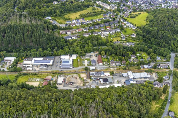 Aerial view, Friedrichshütte industrial estate and Lindenstraße on the railway line, Schuleborn residential area, Schlossbergklinik HGC Kliniken GmbH in the background, Wittgenstein-Kunst, Bad Laasphe, Wittgensteiner Land, North Rhine-Westphalia, Germany, architecture, railway line, Friedrichshütte, buildings, health, commercial area, HGC Kliniken GmbH, houses, industry, infrastructure, clinic, art, landscape, Lindenstraße, aerial view, region, rails, Schlossbergklinik, Schuleborn, settlement, cityscape, structures, urban, traffic, residential area, trains, German town