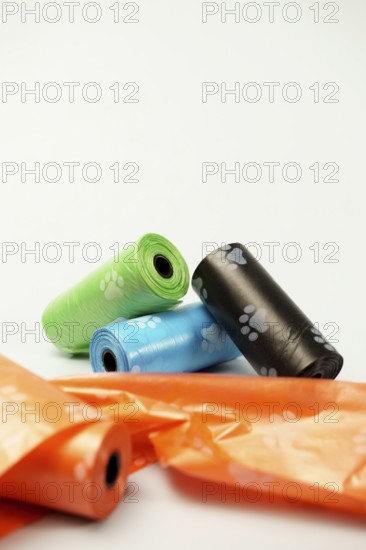 Rolls of biodegradable dog poop bags showing paw prints, promoting responsible pet ownership and environmental consciousness