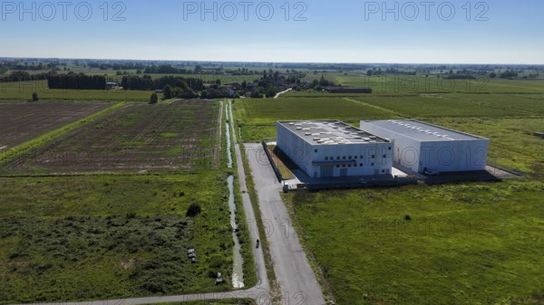Cremona, Italy - August 22nd 2025 Modern data center facility under a clear blue sky surrounded by agricultural fields representing the intersection of technology and rural development in Italy