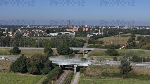 Panoramic view of Cremona skyline and agricultural landscape near a Northern Italian city under a clear blue sky