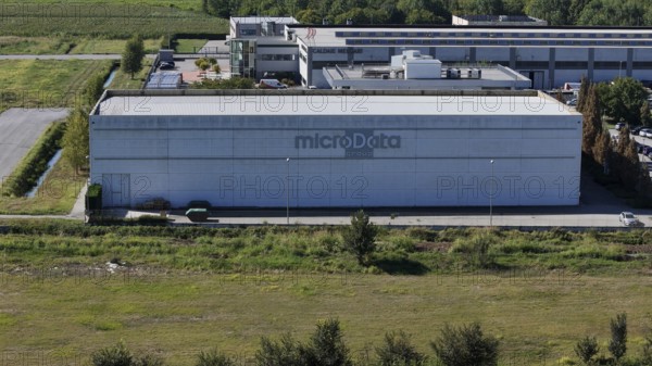 Cremona, Italy August 22nd 2025 Aerial view revealing MicroData Group headquarters, massive data center nestled among verdant landscape and industrial infrastructure