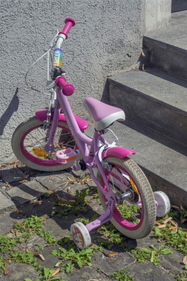 Pink-coloured Unicorn children's bike with training wheels, Dornbirn, Vorarlberg, Austria