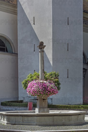 St Martin's Fountain with floral decorations at the parish church of St Martin, Dornbirn, Vorarlberg, Austria