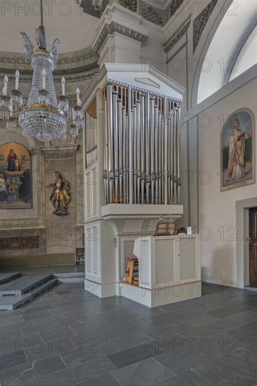 The Roman Catholic parish church of St Martin, interior with side organ, wall frescoes and crystal chandelier, Dornbirn, Vorarlberg, Austria