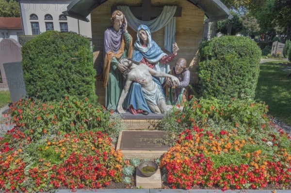 Gravesite with depiction of the Descent from the Cross and floral decoration, Catholic cemetery, Kempten, Allgäu, Bavaria, Germany