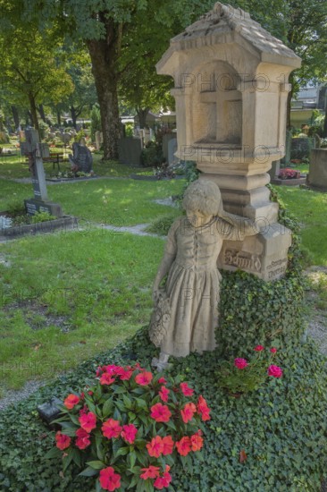 Gravesite with mourning girl figure, ivy and floral decoration, catholic cemetery, Kempten, Allgäu, Bavaria, Germany