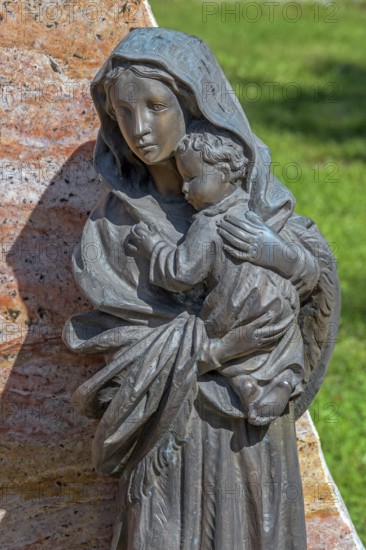Gravesite with bronze figure, mother with child, catholic cemetery, Kempten, Allgäu, Bavaria, Germany