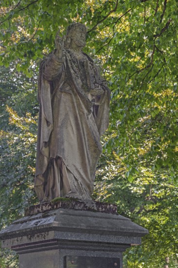 Gravesite with weathered figure of Christ blessing, catholic cemetery, Kempten, Allgäu, Bavaria, Germany