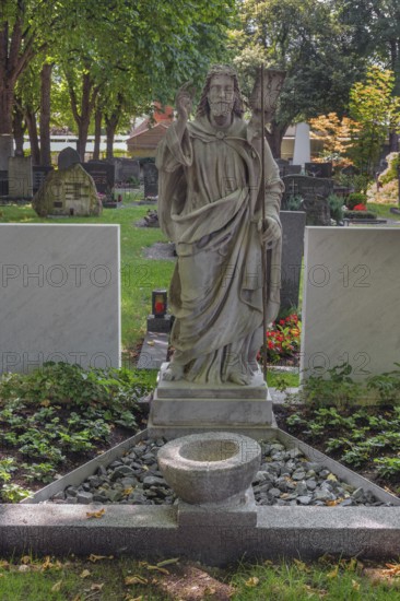 Gravesite with Christ figure, catholic cemetery, Kempten, Allgäu, Bavaria, Germany
