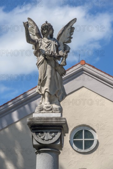 The angel on the fountain column by the funeral parlour, Catholic cemetery, Kempten, Allgäu, Bavaria, Germany
