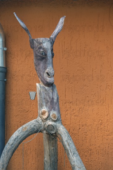 Whimsical tree sculpture, donkey's head with long ears at the Kultur-Wirtschaft in the Allgäuhalle, Kempten, Allgäu, Bavaria, Germany