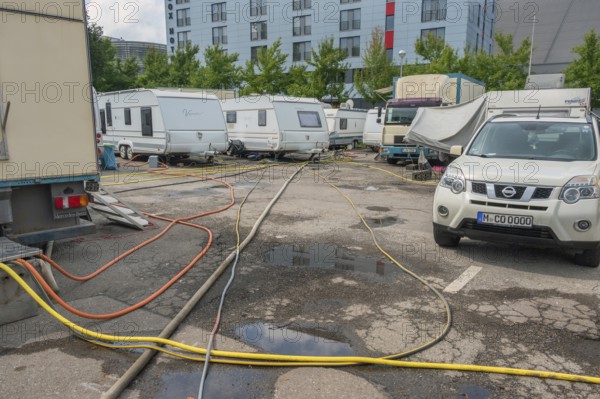 Parked caravans with tangle of water hoses, Circus-Krone, Kempten, Allgäu, Bavaria, Germany