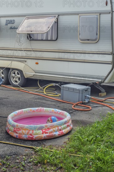 Lord Ambassador caravan with electricity and water connections and children's paddling pool at Circus-Krone, Kempten, Allgäu, Bavaria, Germany