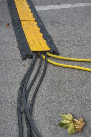 Power cable with cable bridge on asphalt, Circus-Krone, Kempten, Allgäu, Bavaria, Germany
