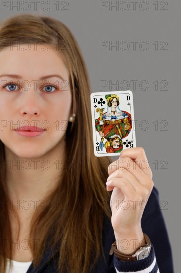 Woman holding a playing card in her hand