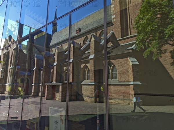 Old town with catholic reflection of St Margaret's Church in glass front, brick building, architecture, religion, Brühl, North Rhine-Westphalia, Germany