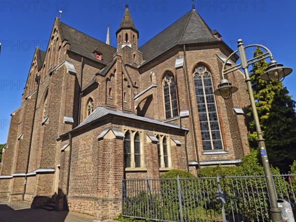 Old town with catholic church St. Margareta, brick building, architecture, religion, lantern, tree, blue sky, sunshine, Brühl, North Rhine-Westphalia, Germany