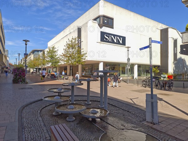 Pedestrian zone with fountain, department stores', pedestrians, traffic-calmed, old town, architecture, shops, young trees, people, blue sky, sunshine, Brühl, North Rhine-Westphalia, Germany