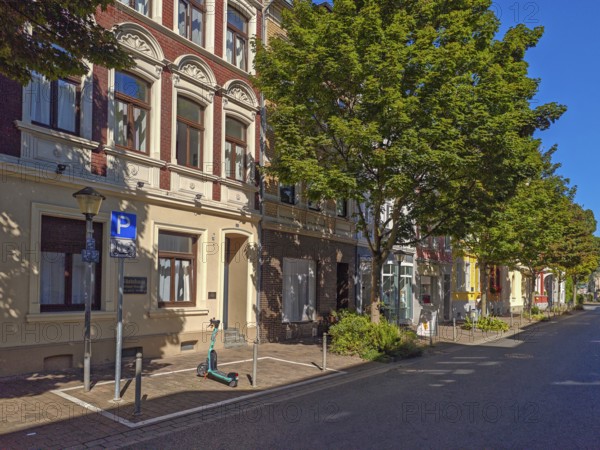 Street in the old town, trees, car park for scooters, e-scooters, blue sky, sunshine, Brühl, North Rhine-Westphalia, Germany