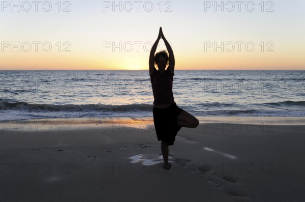 Yoga position, woman showing asana on the beach at Cervantes, Perth, Western Australia, WA, Indian Ocean, Australia