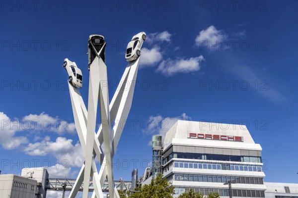 Stuttgart Zuffenhausen with headquarters and logo. Inspiration 911 artwork by Gerry Judah on Porscheplatz: three pillars, each up to 24 metres high, presenting a Porsche 911. Stuttgart, Baden-Württemberg, Germany