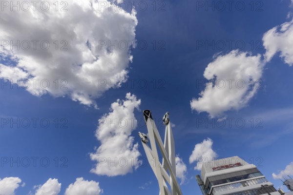 Stuttgart Zuffenhausen with headquarters and logo. Inspiration 911 artwork by Gerry Judah on Porscheplatz: three pillars, each up to 24 metres high, presenting a Porsche 911. Stuttgart, Baden-Württemberg, Germany