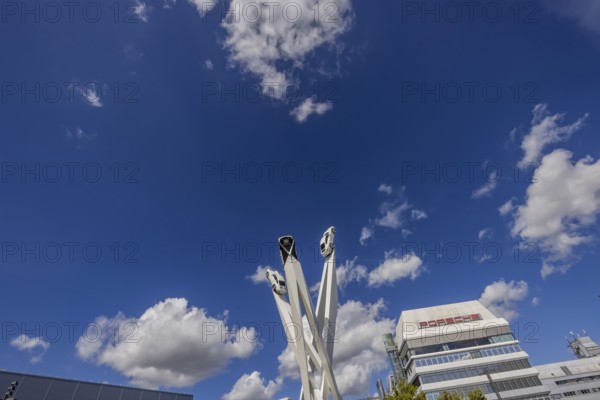 Stuttgart Zuffenhausen with headquarters and logo. Inspiration 911 artwork by Gerry Judah on Porscheplatz: three pillars, each up to 24 metres high, presenting a Porsche 911. Stuttgart, Baden-Württemberg, Germany