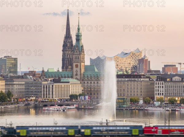 Aerial view of the Inner Alster with Kennedy Bridge, Alster Fountain, Jungfernstieg, City Hall and Elbphilharmonie at sunset, Hamburg, Germany