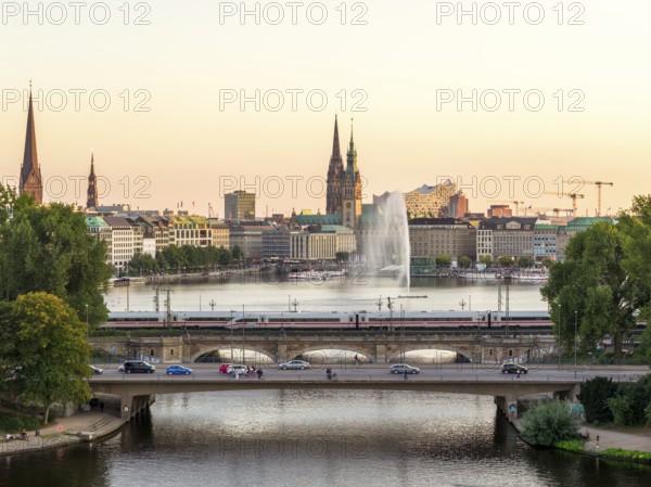Aerial view of the Outer Alster and Inner Alster with Kennedy Bridge, Alster Fountain, Jungfernstieg, City Hall and Elbphilharmonie at sunset, Hamburg, Germany