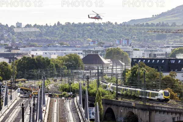Track construction from the air. At Bad Cannstatt railway station, a transport helicopter transports 26 catenary masts to their destination. The masts, weighing up to 2.4 tonnes, were delivered by rail. The reason for this is to improve the infrastructure as part of the Stuttgart 21 project. Stuttgart, Baden-Württemberg, Germany