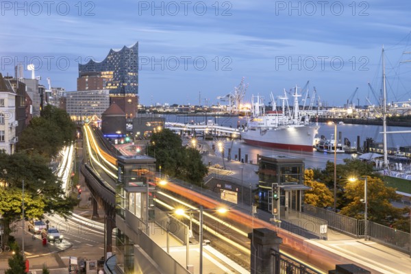 View of the harbour of Hamburg with Landungsbrücken, Jan-Fedder-Promenade, Cap San Diego, light traces of the underground U3 and the Elbphilharmonie at blue hour, Hamburg, Germany