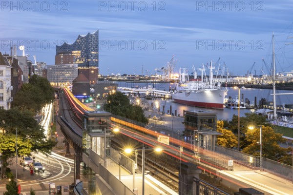 View of the harbour of Hamburg with Landungsbrücken, Jan-Fedder-Promenade, Cap San Diego, light traces of the underground U3 and the Elbphilharmonie at blue hour, Hamburg, Germany