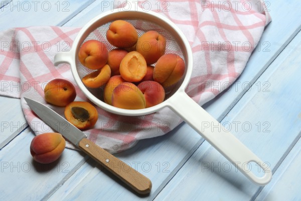 Apricots in colander, halved, Prunus armeniaca