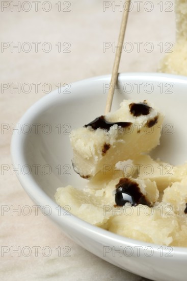 Parmesan cheese, pieces of cheese with crema di balsamico in small bowls